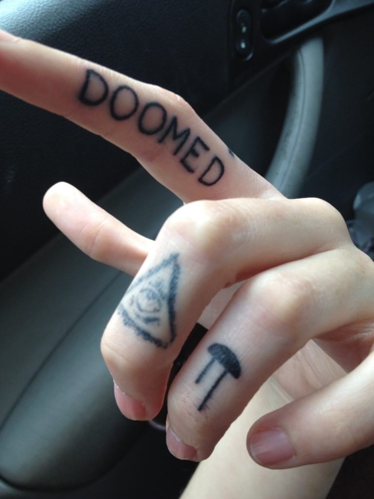 doomed finger tattoo